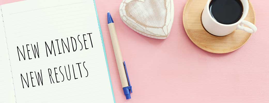 New mindset... new results written on a notepad with a coffee cup and