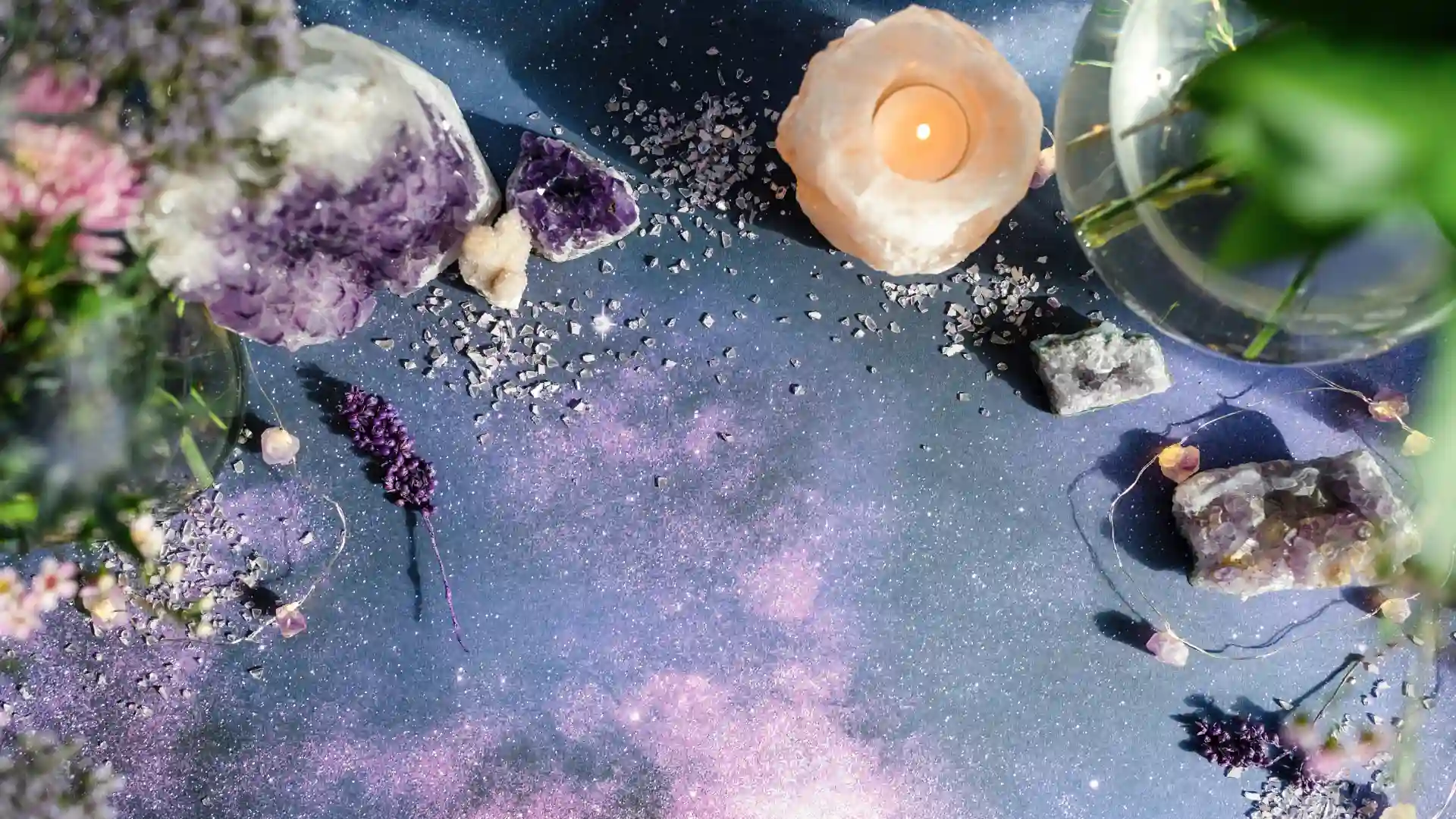 Cosmic flat lay featuring purple crystals, lavender, a glowing candle, and scattered stones, creating a serene and aligned vibe—perfect for a Website in a Day service..